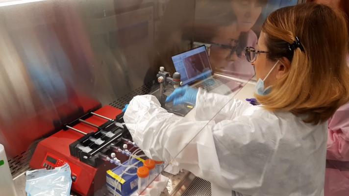 Researcher at the Kennedy Space Center preparing the programmable syringe pumps 