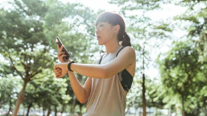 A person checking their fitness tracker data on their mobile phone