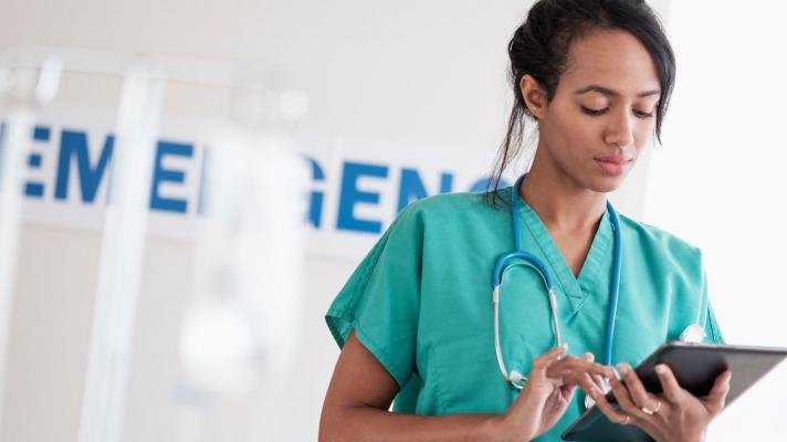 Healthcare provider looking at a tablet